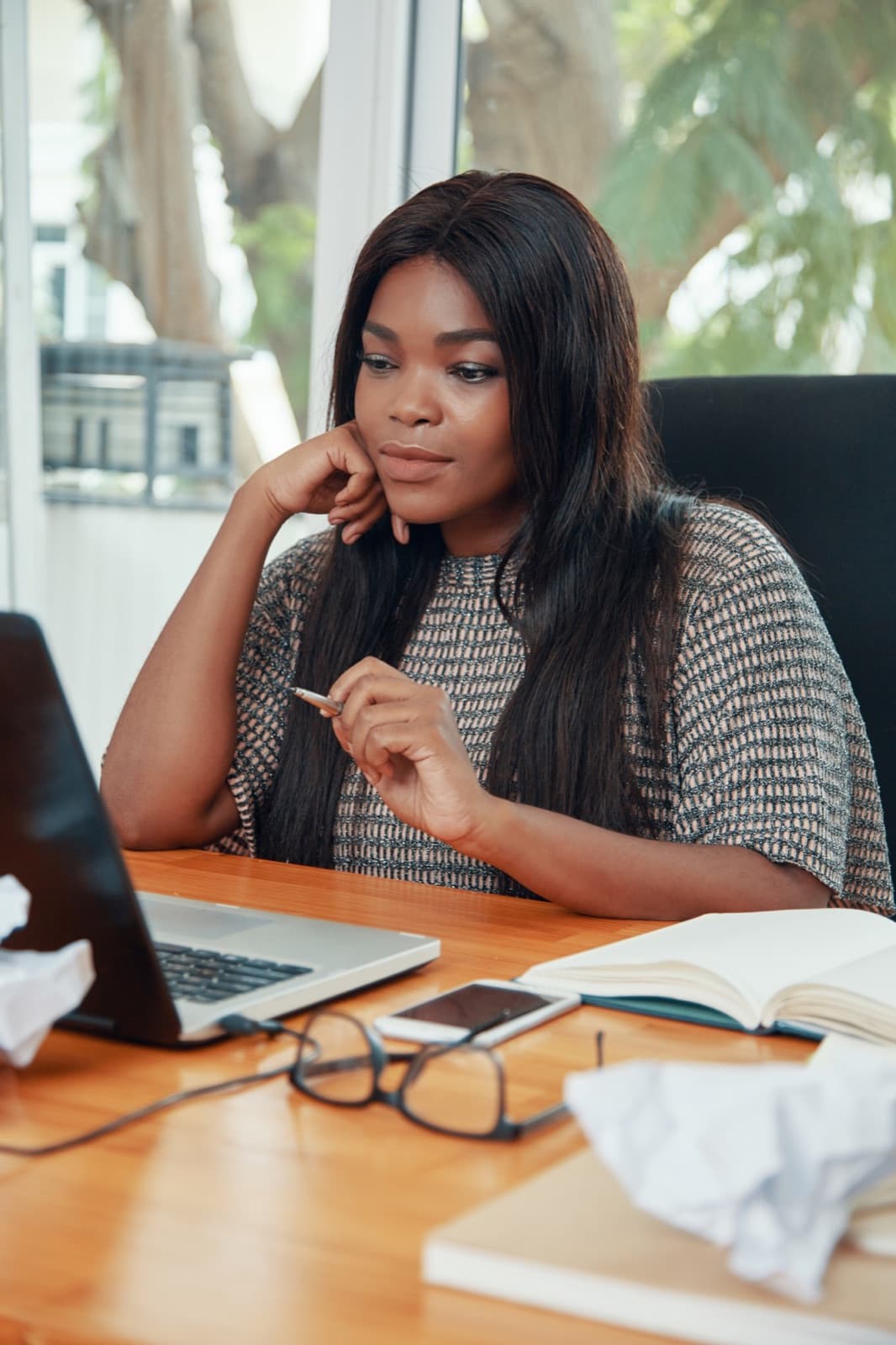 A small business owner working at her computer in a bright office